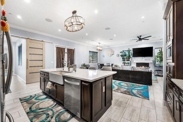Chandelier, Dining room, Fireplace, Interior, Kitchen, Living room, Pendant Lights, Recessed Lighting, Stainless Steel Appliances