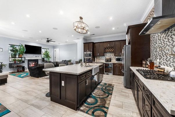 Chandelier, Fireplace, Interior, Kitchen, Living room, Recessed Lighting, Stainless Steel Appliances