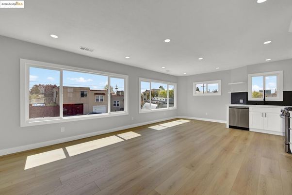 Empty room, Interior, Kitchen, Recessed Lighting, Stainless Steel Appliances, Wood Texture Flooring