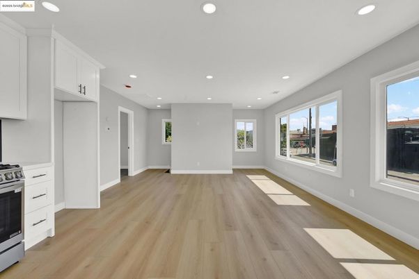 Empty room, Interior, Kitchen, Recessed Lighting, Stainless Steel Appliances, Wood Texture Flooring