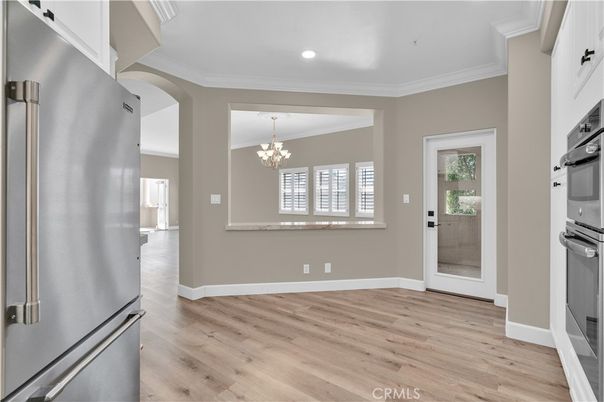 Chandelier, Empty room, Interior, Kitchen, Recessed Lighting, Stainless Steel Appliances, Wood Texture Flooring