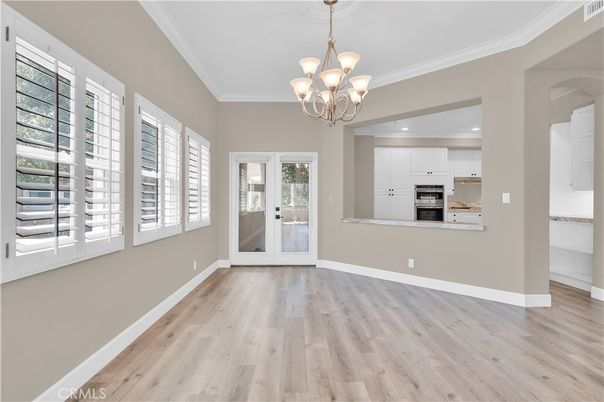 Chandelier, Empty room, Interior, Kitchen, Recessed Lighting, Stainless Steel Appliances, Wood Texture Flooring