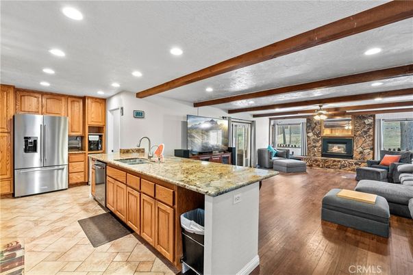 Fireplace, Interior, Kitchen, Living room, Recessed Lighting, Stainless Steel Appliances, Stone Walls, Wooden Beams, Wood Texture Flooring