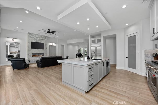 Fireplace, Interior, Kitchen, Living room, Recessed Lighting, Stainless Steel Appliances, Wood Texture Flooring