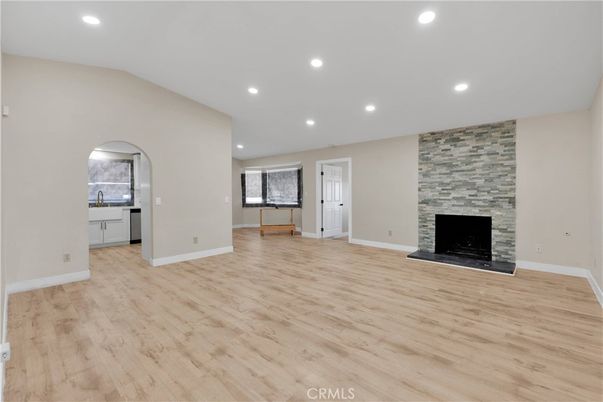 Empty room, Fireplace, Interior, Recessed Lighting, Stone Walls, Wood Texture Flooring