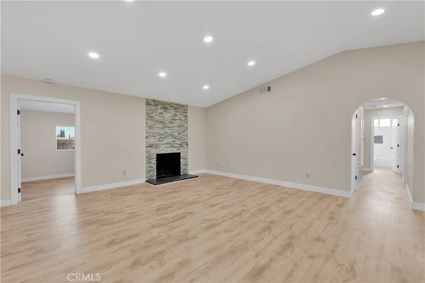Empty room, Fireplace, Interior, Recessed Lighting, Stone Walls, Wood Texture Flooring