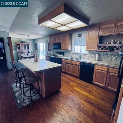 Interior, Kitchen, Pendant Lights, Tile Countertops, Wood Texture Flooring