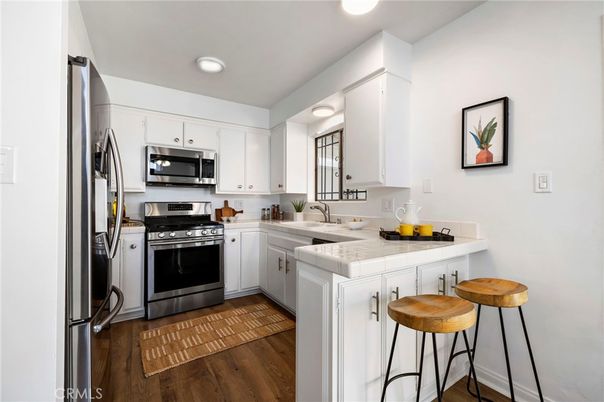 Interior, Kitchen, Recessed Lighting, Stainless Steel Appliances, Tile Countertops, Wood Texture Flooring
