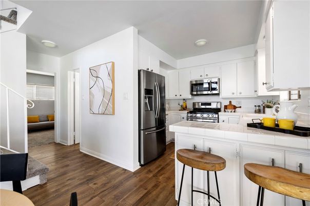Interior, Kitchen, Stainless Steel Appliances, Tile Countertops, Wood Texture Flooring