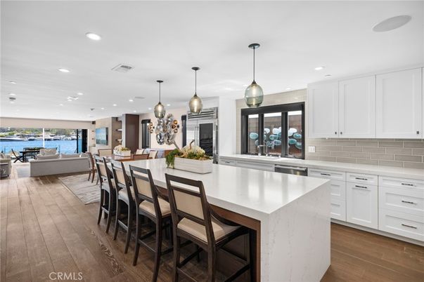 Dining room, Interior, Kitchen, Living room, Pendant Lights, Recessed Lighting, Stainless Steel Appliances, Water, Wood Texture Flooring