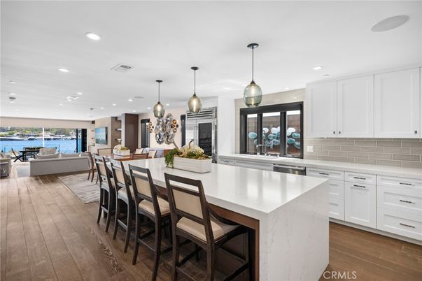 Dining room, Interior, Kitchen, Pendant Lights, Recessed Lighting, Stainless Steel Appliances, Water, Wood Texture Flooring
