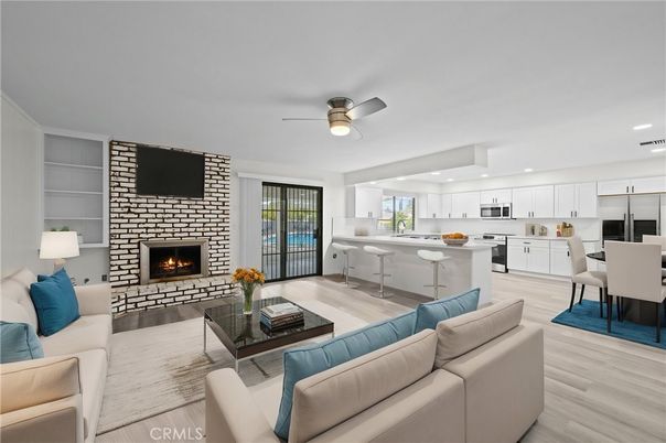 Dining room, Fireplace, Interior, Kitchen, Living room, Recessed Lighting, Stainless Steel Appliances, Wood Texture Flooring