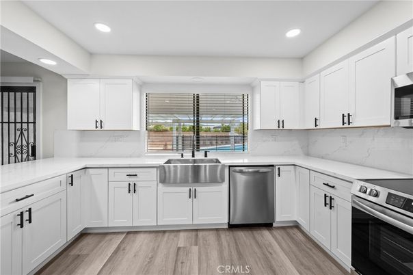 Interior, Kitchen, Marble Walls, Recessed Lighting, Stainless Steel Appliances, Wood Texture Flooring