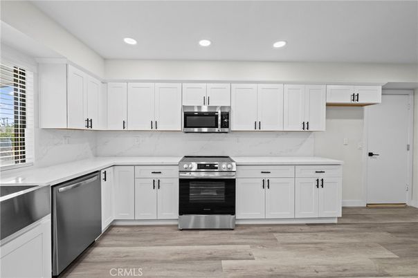 Interior, Kitchen, Marble Walls, Recessed Lighting, Stainless Steel Appliances, Wood Texture Flooring