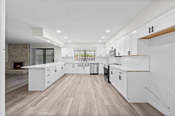 Fireplace, Interior, Kitchen, Recessed Lighting, Stainless Steel Appliances, Stone Walls, Wood Texture Flooring