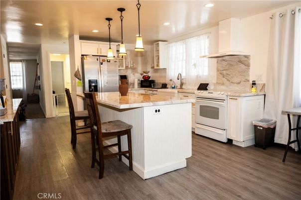 Interior, Kitchen, Marble Walls, Pendant Lights, Recessed Lighting, Stainless Steel Appliances, Wood Texture Flooring