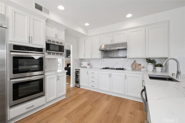 Interior, Kitchen, Marble Walls, Recessed Lighting, Stainless Steel Appliances, Wood Texture Flooring