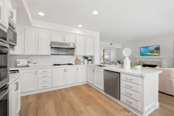 Interior, Kitchen, Marble Walls, Recessed Lighting, Stainless Steel Appliances, Wood Texture Flooring
