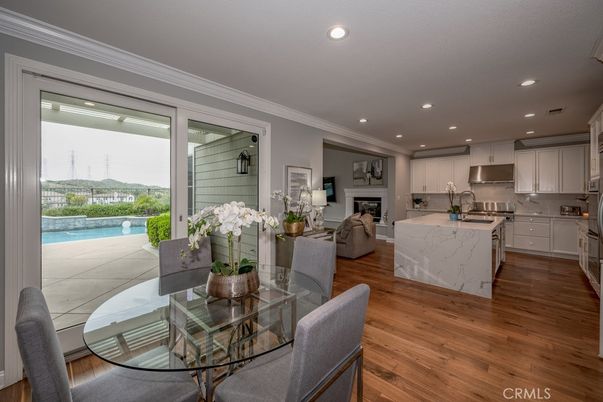 Dining room, Fireplace, Interior, Kitchen, Living room, Recessed Lighting, Stainless Steel Appliances, Wood Texture Flooring