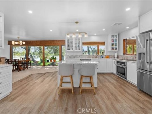 Chandelier, Dining room, Interior, Kitchen, Pendant Lights, Recessed Lighting, Stainless Steel Appliances, Wood Texture Flooring