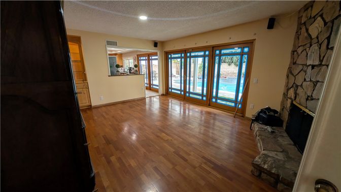 Empty room, Fireplace, Interior, Recessed Lighting, Stone Walls, Wood Texture Flooring