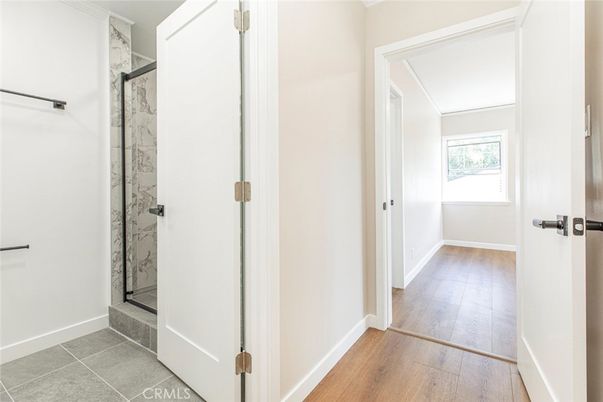 Bathroom, Glass Shower, Interior, Marble Walls, Wood Texture Flooring