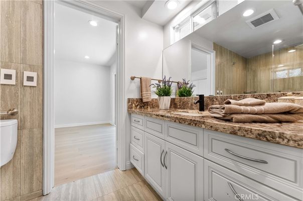 Bathroom, Dual Sink Vanities, Glass Shower, Interior, Recessed Lighting, Wood Texture Flooring