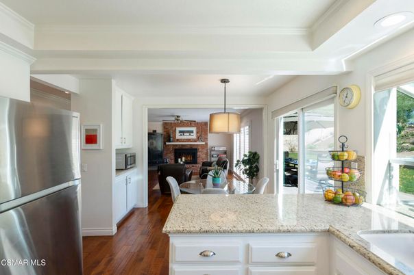 Dining room, Fireplace, Interior, Kitchen, Living room, Pendant Lights, Stainless Steel Appliances, Wood Texture Flooring