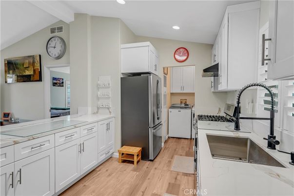 Interior, Kitchen, Recessed Lighting, Washer, Wood Texture Flooring