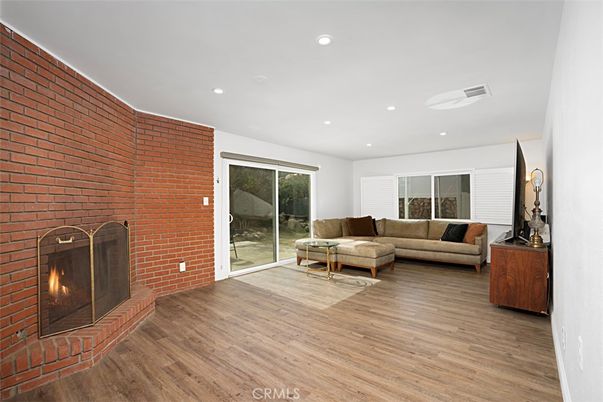 Fireplace, Interior, Living room, Recessed Lighting, Stone Walls, Wood Texture Flooring