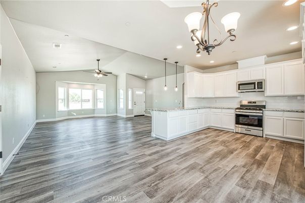 Chandelier, Empty room, Interior, Kitchen, Pendant Lights, Recessed Lighting, Stainless Steel Appliances, Wood Texture Flooring