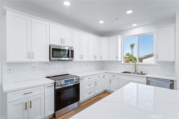 Interior, Kitchen, Marble Walls, Recessed Lighting, Stainless Steel Appliances, Wood Texture Flooring