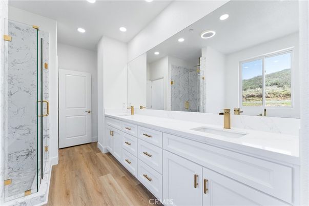 Bathroom, Dual Sink Vanities, Glass Shower, Interior, Marble Walls, Recessed Lighting, Wood Texture Flooring