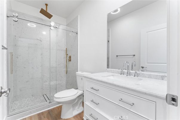 Bathroom, Glass Shower, Interior, Marble Walls, Recessed Lighting, Wood Texture Flooring