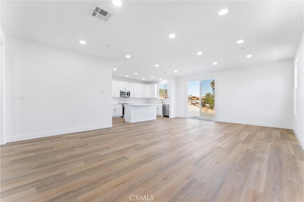 Empty room, Interior, Kitchen, Recessed Lighting, Stainless Steel Appliances, Wood Texture Flooring
