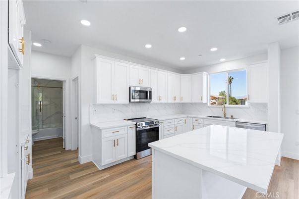 Interior, Kitchen, Marble Walls, Recessed Lighting, Stainless Steel Appliances, Wood Texture Flooring