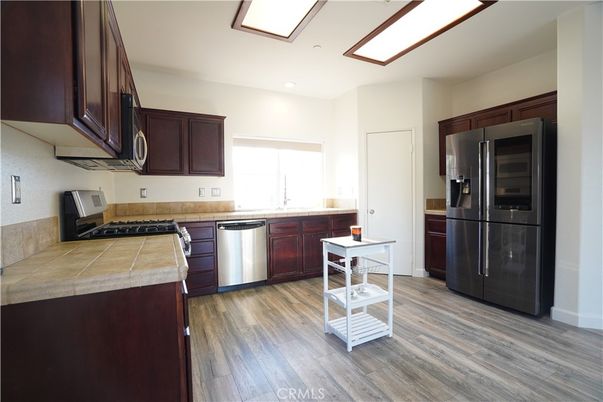 Interior, Kitchen, Recessed Lighting, Tile Countertops, Wood Texture Flooring