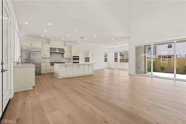 Empty room, Interior, Kitchen, Recessed Lighting, Stainless Steel Appliances, Wood Texture Flooring