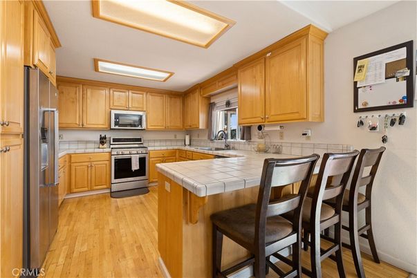 Interior, Kitchen, Stainless Steel Appliances, Tile Countertops, Wood Texture Flooring
