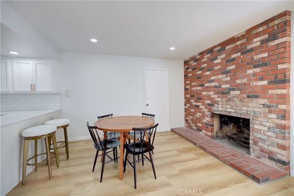 Dining room, Fireplace, Interior, Recessed Lighting, Stone Walls, Wood Texture Flooring