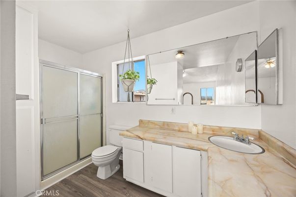 Bathroom, Dual Sink Vanities, Glass Shower, Interior, Pendant Lights, Wood Texture Flooring