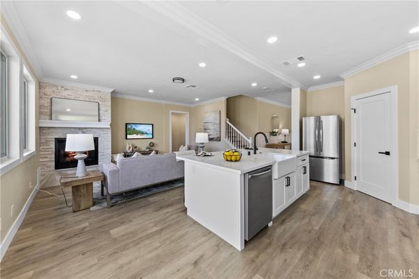 Fireplace, Interior, Kitchen, Living room, Recessed Lighting, Stainless Steel Appliances, Wood Texture Flooring
