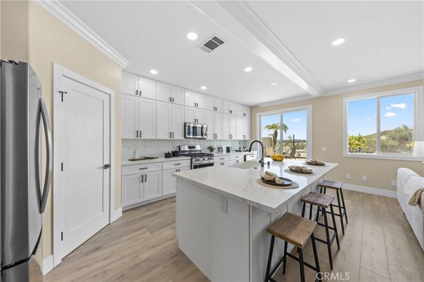 Interior, Kitchen, Marble Walls, Recessed Lighting, Stainless Steel Appliances, Wood Texture Flooring