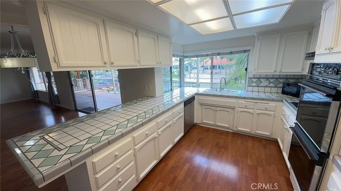 Interior, Kitchen, Pendant Lights, Tile Countertops, Wood Texture Flooring