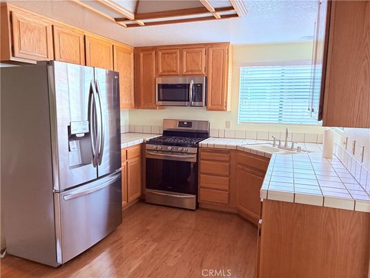 Interior, Kitchen, Stainless Steel Appliances, Tile Countertops, Wood Texture Flooring