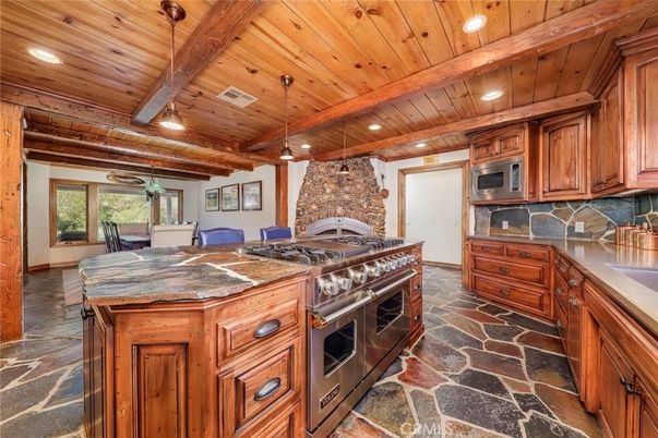 Dining room, Fireplace, Interior, Kitchen, Recessed Lighting, Stainless Steel Appliances, Stone Walls, Wooden Beams, Wooden Ceilings