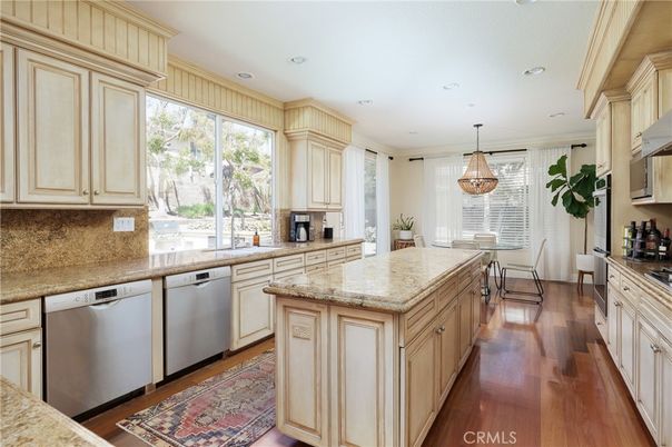 Chandelier, Dining room, Interior, Kitchen, Pendant Lights, Recessed Lighting, Stainless Steel Appliances, Wood Texture Flooring