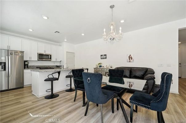 Chandelier, Dining room, Interior, Kitchen, Recessed Lighting, Stainless Steel Appliances, Wood Texture Flooring