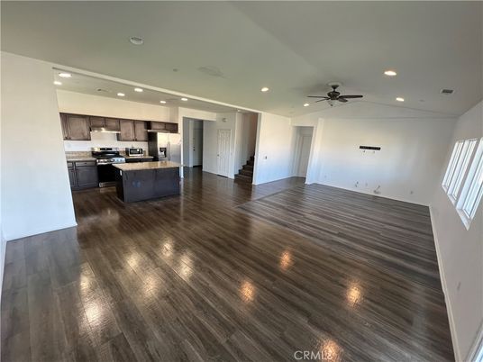 Empty room, Interior, Kitchen, Recessed Lighting, Stainless Steel Appliances, Wood Texture Flooring