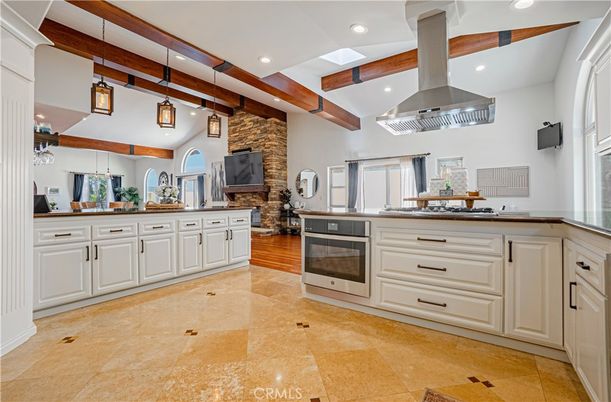 Fireplace, Interior, Kitchen, Pendant Lights, Recessed Lighting, Stainless Steel Appliances, Stone Walls, Wooden Beams